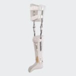 Patient walking with a modern carbon fiber KAFO long leg brace in a clinic