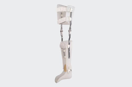 Patient walking with a modern carbon fiber KAFO long leg brace in a clinic